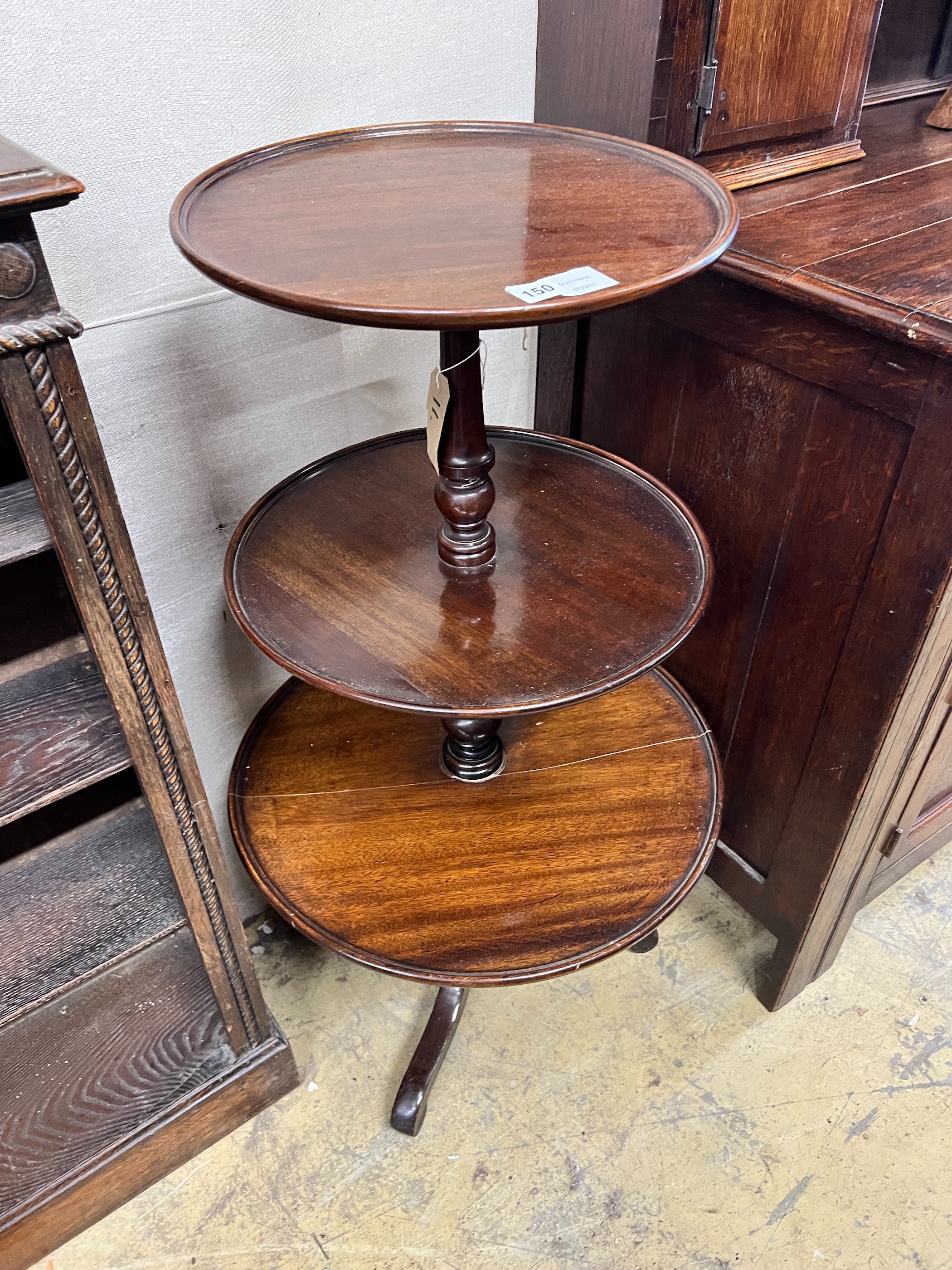 A George III and later mahogany three tier dumb waiter, height 102cm
